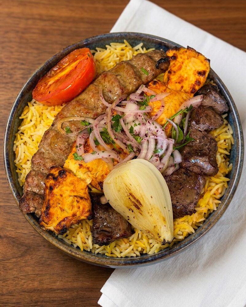 Mixed grill plate with kebab, chicken, rice and grilled tomato