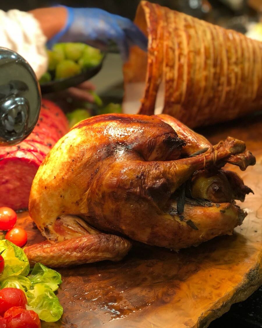 Whole roast turkey on a wooden carving board