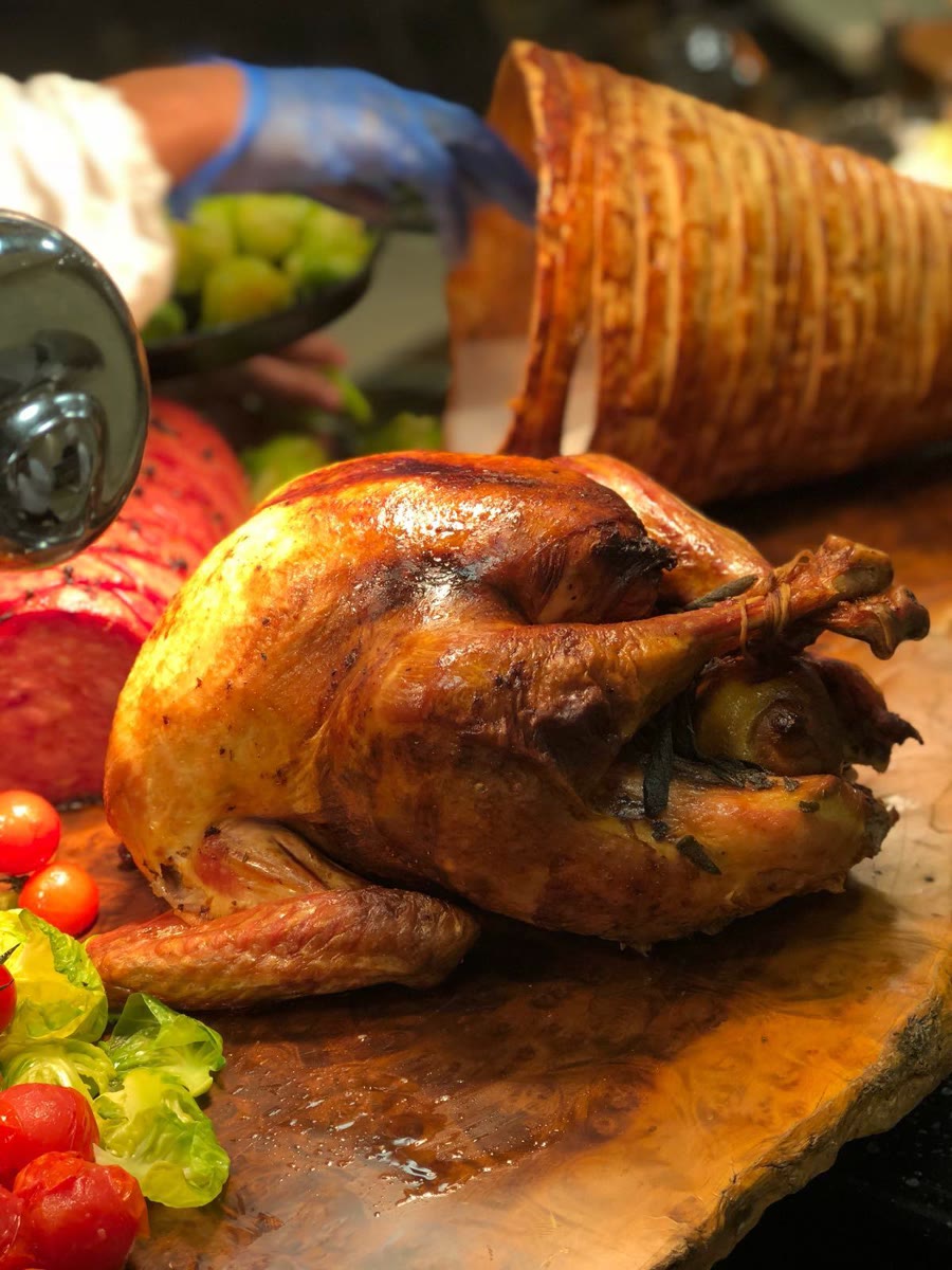 Whole roast turkey on a wooden carving board
